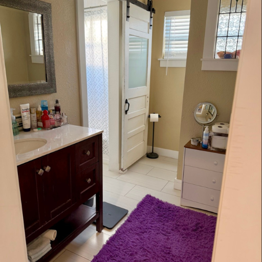 Second full bathroom with barn sliding door and wood vanity at Cottage Delasandri