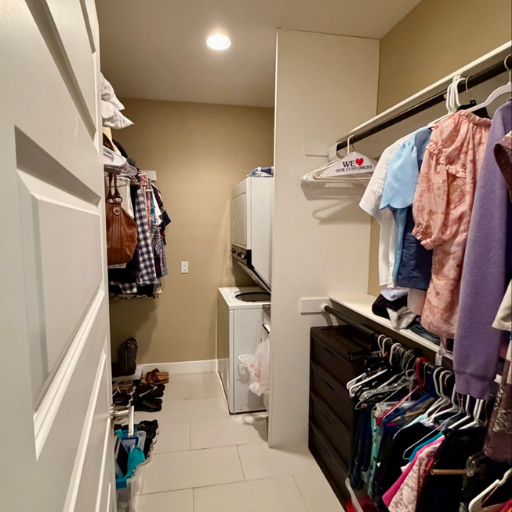Walk-in closet with in-unit washer/dryer at Cottage at Delasandri women's sober living