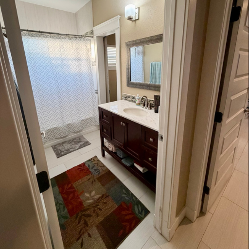Clean full bathroom with dark wood vanity and mosaic tile at 1010-B Delasandri Ln
