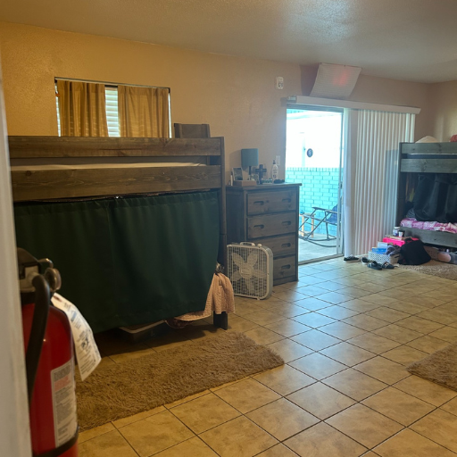 Second bedroom with bunk beds and patio access at Delasandri Lane