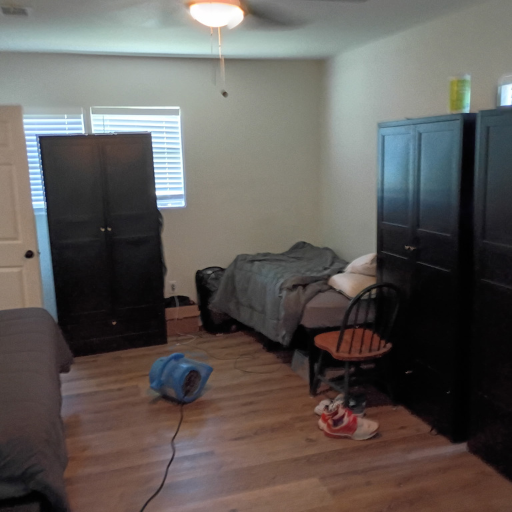 Furnished shared bedroom with dark wardrobes and hardwood floors at Idaho Drive