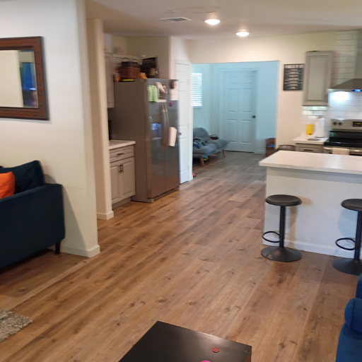 Full interior view showing kitchen, fridge and open layout at Idaho Drive men's sober living