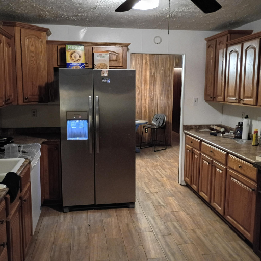 Full kitchen with wood-panel accents at Sue Drive women's sober living home